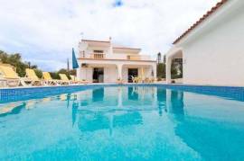 Traditional south-facing villa with swimming pool and distant sea views, set on a very private plot with independent garage.