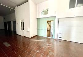 Large garage with mezzanine and bathroom.