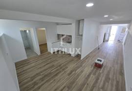 Covered and closed parking transformed into a T0+1 apartment