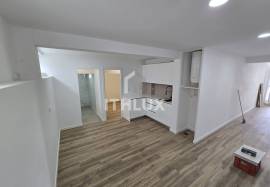 Covered and closed parking transformed into a T0+1 apartment