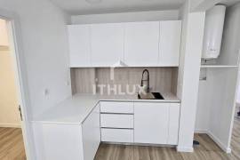 Covered and closed parking transformed into a T0+1 apartment